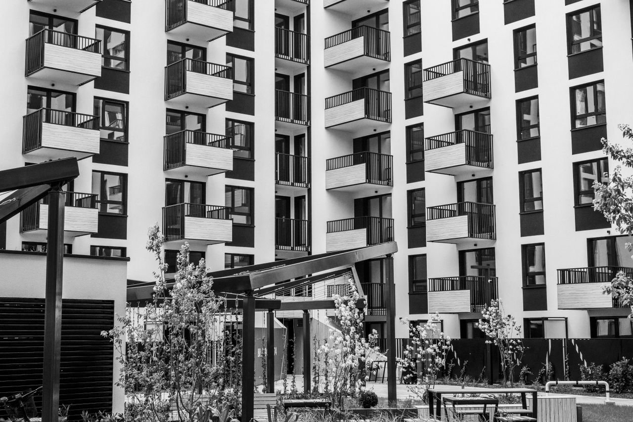 creative-03 Contemporary urban apartment building with balconies and courtyard, black and white.